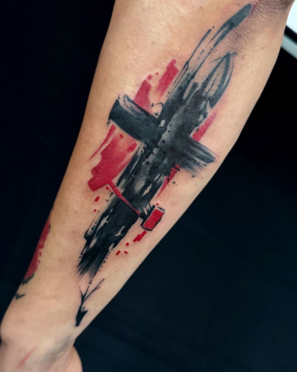 Nachher: Kreuz aus schwarzen Pinselstrichen mit roten Flächen auf dem Unterarm